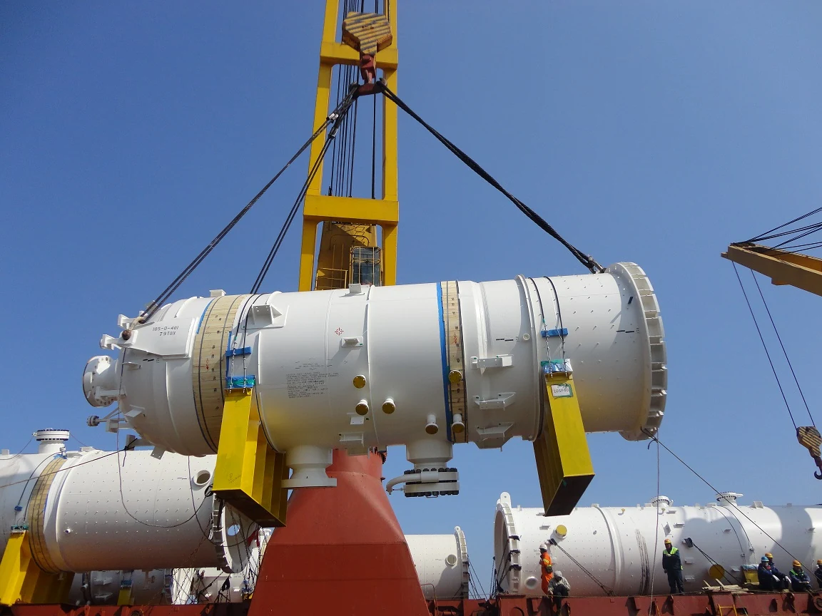 A large drum being lifted aboard using a spreader beam.