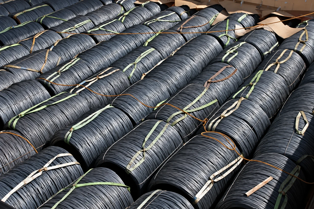 Bundled wire rod coils arranged in rows within the hold.